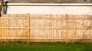 tall brown wooden property fence